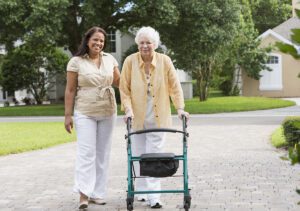 Caregiver helping senior take a walk