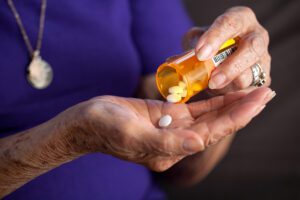 Senior woman taking prescription medication drug